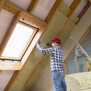 Man installing thermal roof insulation layer